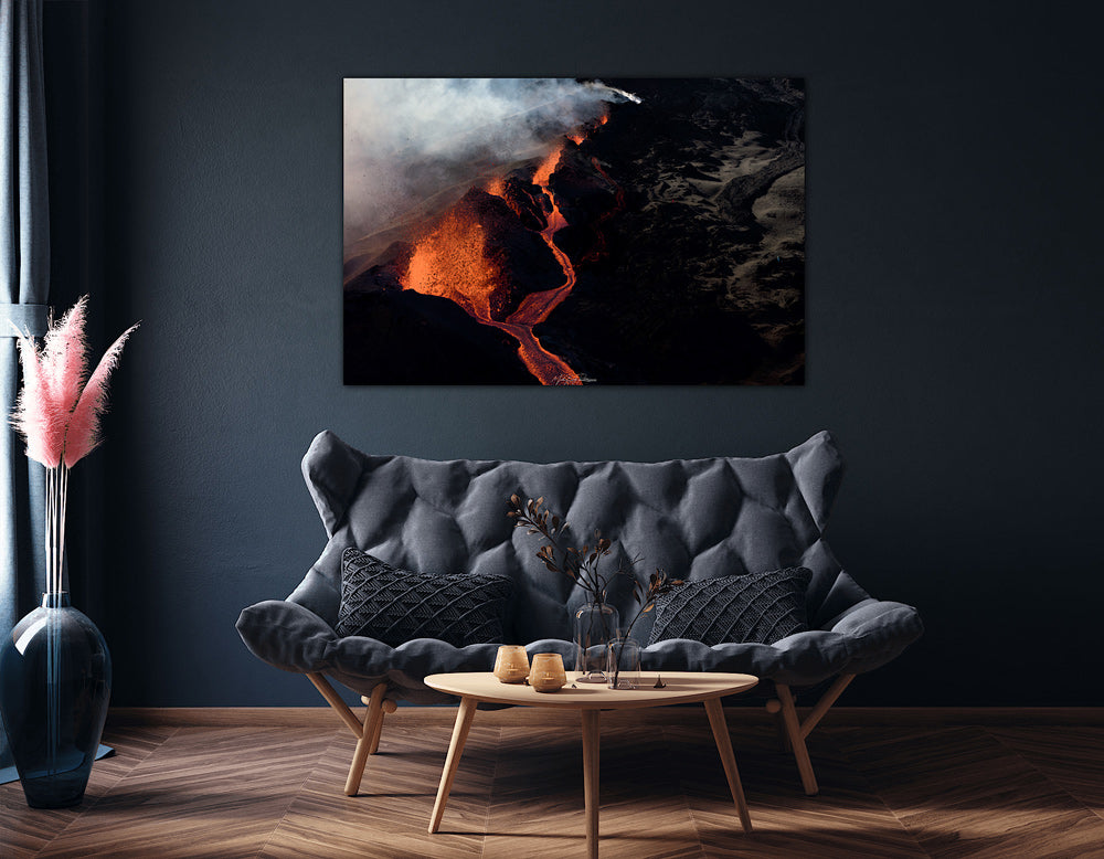 Lava Edge, Piton de la Fournaise mounted print in a modern living room with a dark gray sofa, wooden coffee table.