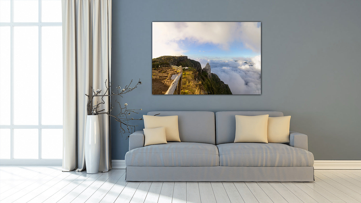 Piton Maïdo Reunion Island wall art print in a modern living room with a gray sofa, decorative pillows, and a large landscape painting on the wall.